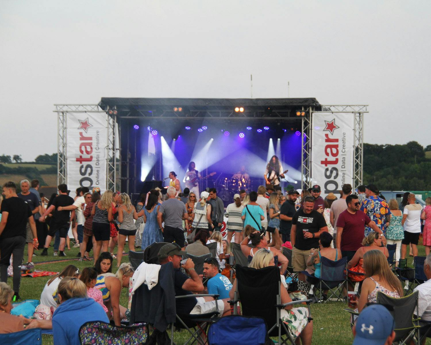 a stage at razzfest with an artist performing and a crowd watching