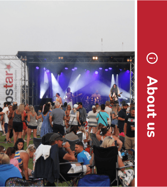 a stage at razzfest with an artist performing and a crowd watching